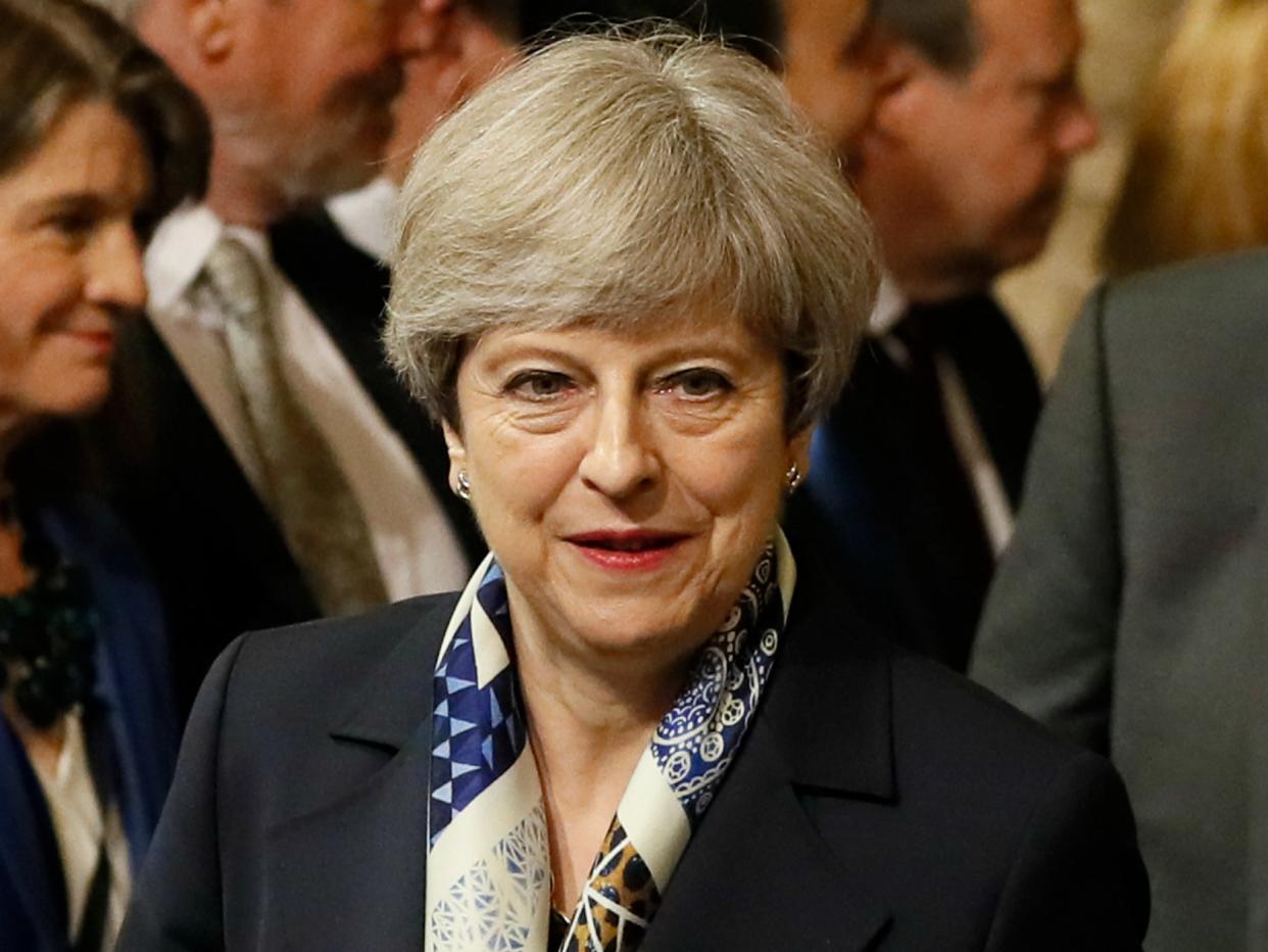 British Prime Minister Theresa May walks through the House of Commons to attend the the State Opening of Parliament: Kirsty Wigglesworth/Getty