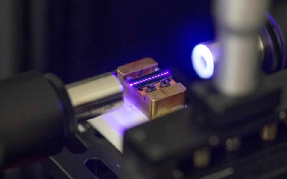 A laser tests the optical waveguide of a chip for quantum computing in a laboratory at the technology company Q.ant in Stuttgart (AFP via Getty Images)