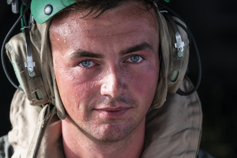 Sweat beads up U.S. Marine Corps Lance Cpl. Brandon Oldham's face as he waits to take off after loading aid onto a VM-22 Osprey at Toussaint Louverture International Airport, Saturday, Aug. 28, 2021, in Port-au-Prince, Haiti. The VMM-266, "Fighting Griffins," from Marine Corps Air Station New River, from Jacksonville, N.C., are flying in support of Joint Task Force Haiti after a 7.2 magnitude earthquake on Aug. 22, caused heavy damage to the country. (AP Photo/Alex Brandon)