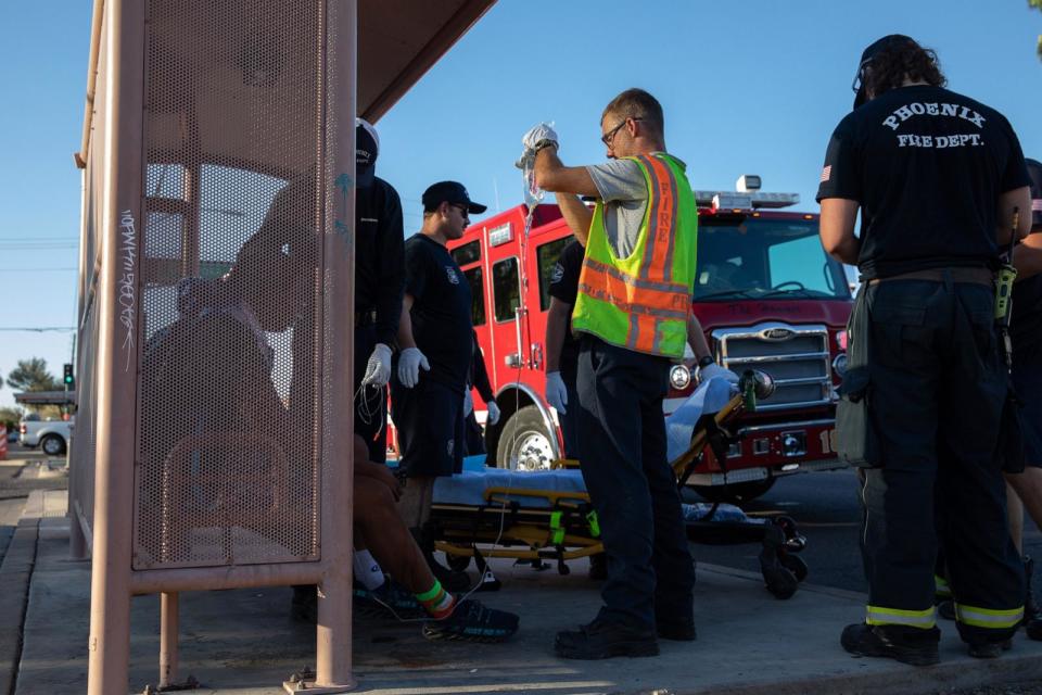 PHOTO: In this July 20, 2023, file photo, firefighters from Phoenix Fire Engine 18 administer fluids to a resident having trouble breathing during a heat wave in Phoenix, Arizona. (Bloomberg via Getty Images, FILE)