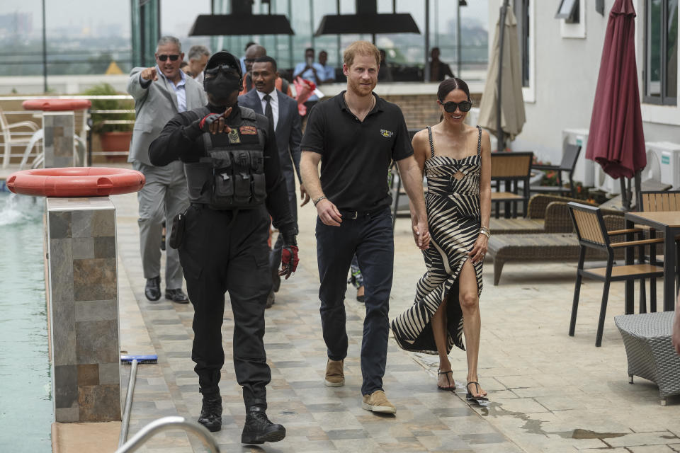 Meghan Markle walks with Prince Harry in Nigeria wearing a Johanna Ortiz dress