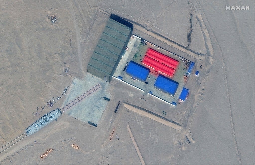 This handout satellite image released by Maxar Technologies on November 8, 2021 shows a rail terminus and a target storage building in Ruoqiang county in the Taklamakan Desert, China's western Xinjiang region on October 8, 2021 (Satellite image Â©2021 Maxar Tech)