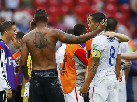 Germany's Jerome Boateng (2nd L) touches the head of Clint Dempsey of the U.S. at the end of their 2014 World Cup Group G soccer match at the Pernambuco arena in Recife June 26, 2014. REUTERS/Brian Snyder