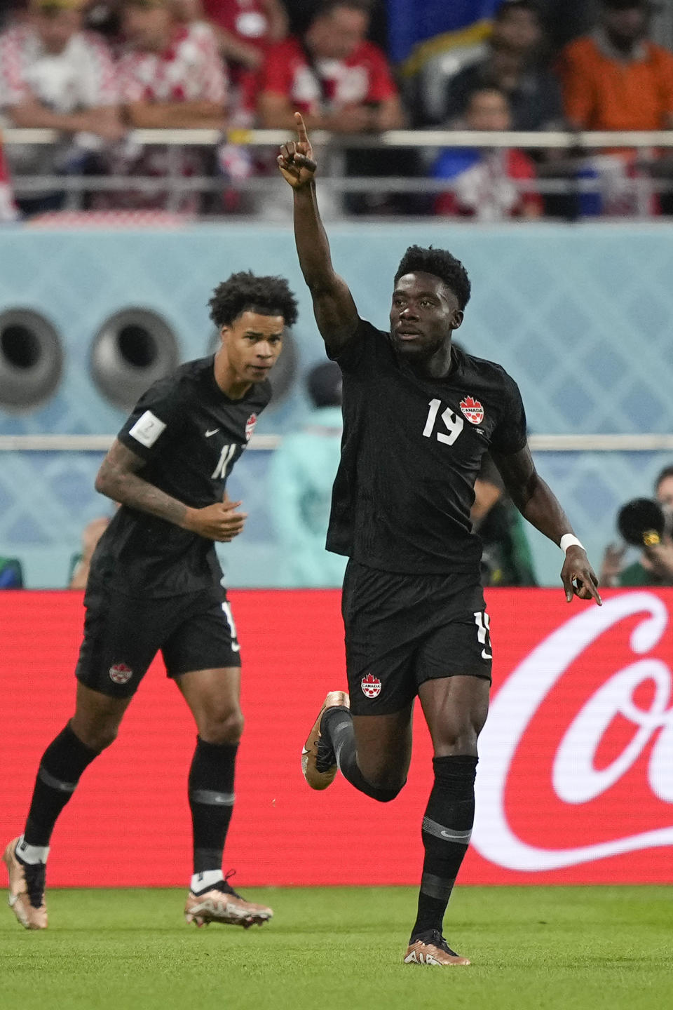 Canada's Alphonso Davies, right, celebrates after scoring the opening goal during the World Cup group F soccer match between Croatia and Canada, at the Khalifa International Stadium in Doha, Qatar, Sunday, Nov. 27, 2022. (AP Photo/Martin Meissner)