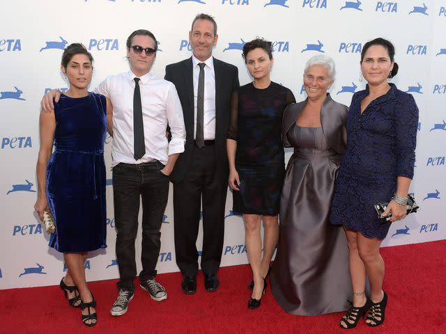 <p>Jason Kempin/Getty</p> Summer Phoenix , Joaquin Phoenix, Jeffrey Weisberg, Rain Phoenix, Arlyn Phoenix and Liberty Phoenix at PETA's 35th Anniversary Party in 2015.