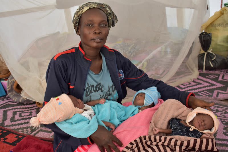 Fatime Eliane, a Cameroonian woman, holds her newly born triplets at the refugee camp on the outskirts of N'djamena