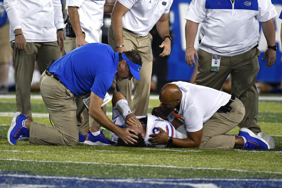 Florida coach Dan Mullen consoles quarterback Feleipe Franks (13) as he lies injured on the field during the second half of the team's NCAA college football game in Lexington, Ky., Saturday, Sept. 14, 2019. Florida won 29-21. (AP Photo/Timothy D. Easley)