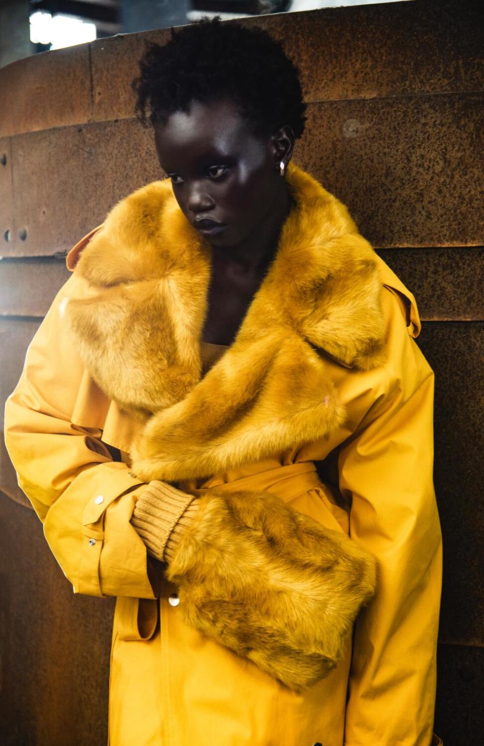 Model wears a yellow coat
