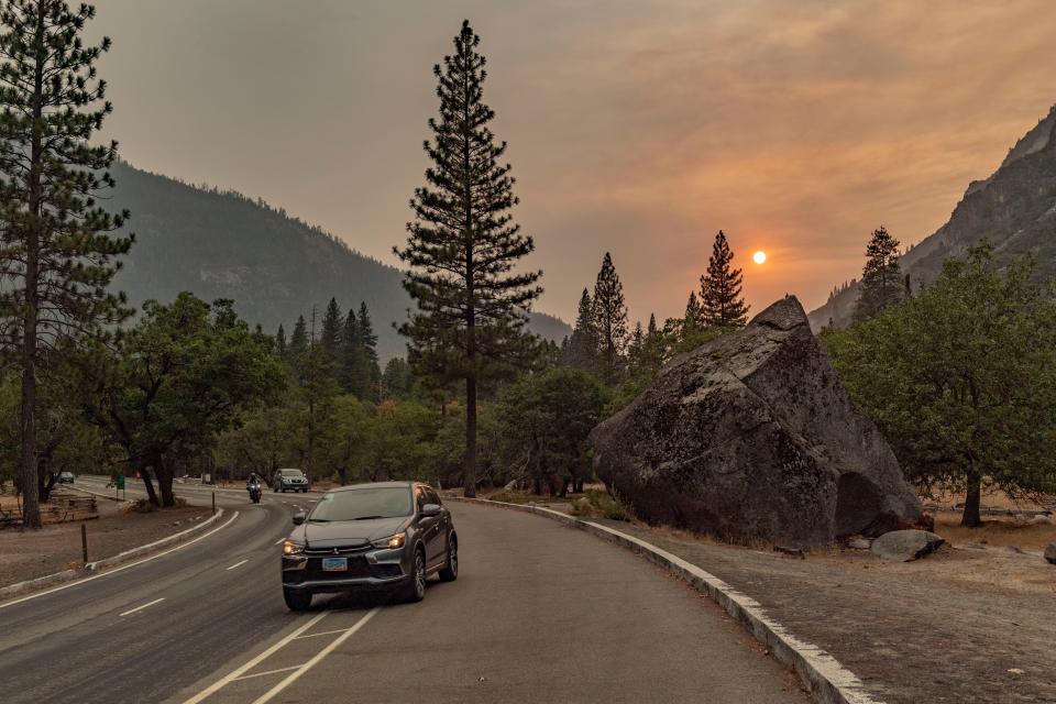 A sunset peeks through smoke from the Creek Fire on the valley floor of Yosemite National Park on Wednesday, September 9, 2020. 