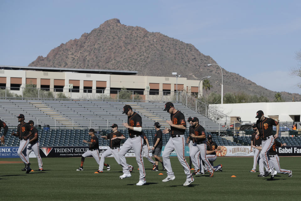 The San Francisco Giants run during spring training baseball practice, Friday, Feb. 14, 2020, in Scottsdale, Ariz. (AP Photo/Darron Cummings)