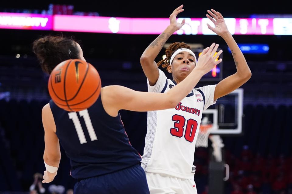 St. John's Kadaja Bailey (30) loses control of the ball as Connecticut's Lou Lopez Senechal (11) defends during the first half of an NCAA basetball game Wednesday, Jan. 11, 2023, in New York. (AP Photo/Frank Franklin II)