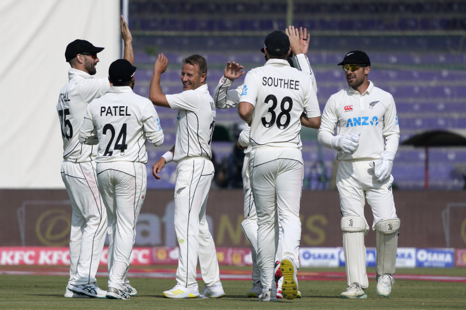 New Zealand's Neil Wagner, center, celebrates with teammate after taking the wicket of Pakistan's Nauman Ali during the second day of first test cricket match between Pakistan and New Zealand, in Karachi, Pakistan, Tuesday, Dec. 27, 2022. (AP Photo/Fareed Khan)