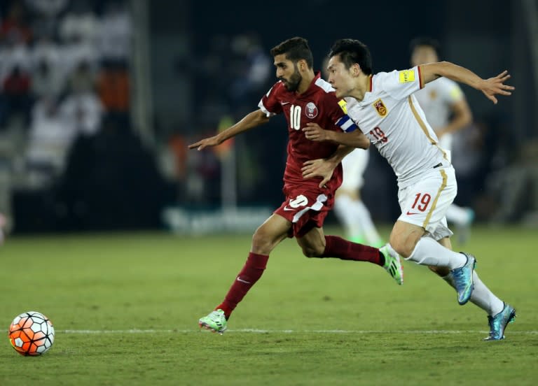 Qatari player Hassan Al-Haidos (L) fights for the header with Chinese player Zheng Long during the AFC qualifying football match for the 2018 FIFA World Cup on October 8, 2015 at Jassim Bin Hamad Stadium in Doha