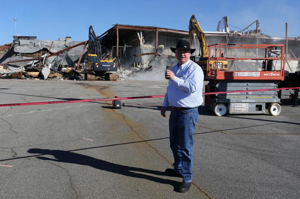 Demolition crews began destroying 100,000 square feet of the McFarland Mall property Tuesday, Feb. 23, 2021, in Tuscaloosa. Real estate developer Stan Pate uses his phone and speaks to bystanders as the work proceeds. [Staff Photo/Gary Cosby Jr.]