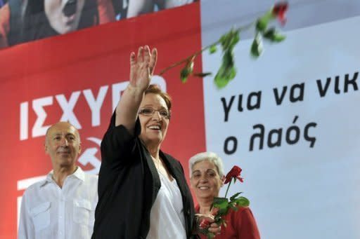 Greek Communist party leader Aleka Papariga throws flowers to supporters during the party's main pre-election rally in Athens on June 15. Eurogroup chief Jean-Claude Juncker warned a radical left victory in Greece would have "unpredictable" consequences for the eurozone as Greeks fed up with austerity prepared for Sunday's elections