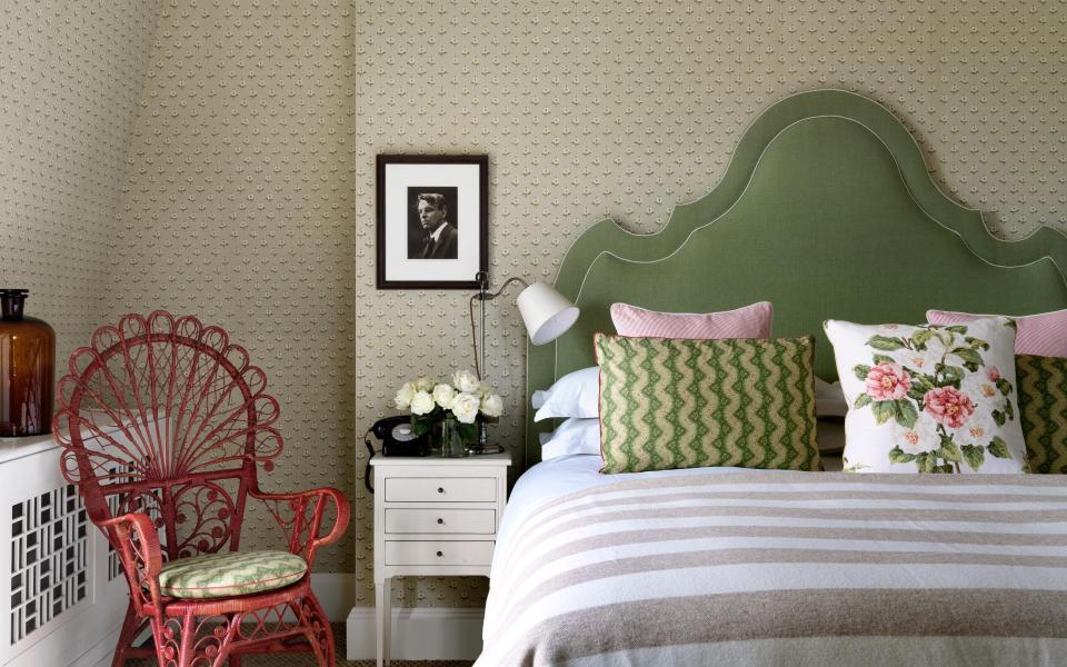 Beaverbrook bedroom with green bed and red chair