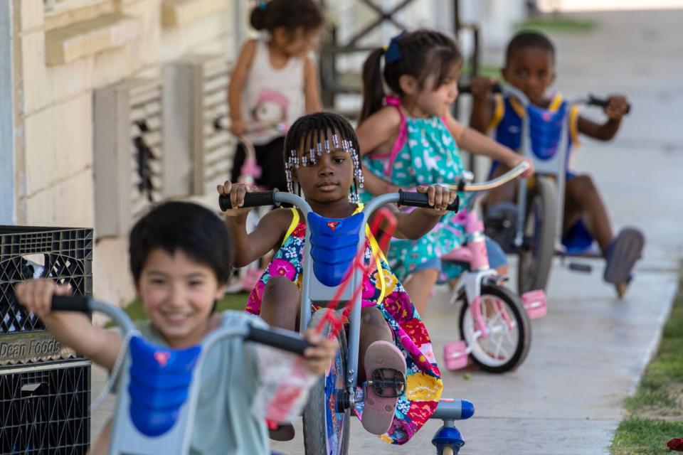 Children on tricycles at the shelter in Riverside County.