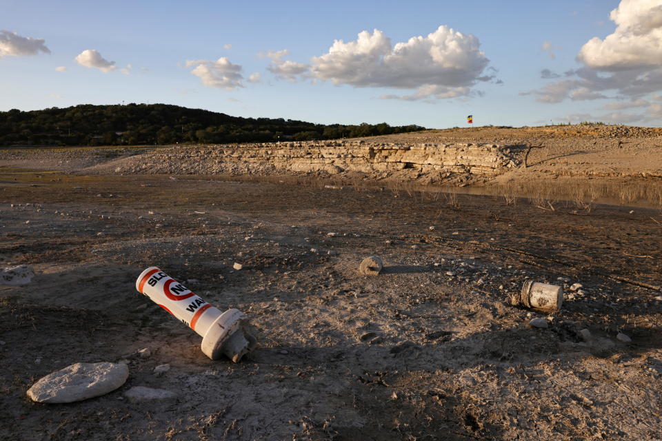 A buoy left high and dry on a parched lake.