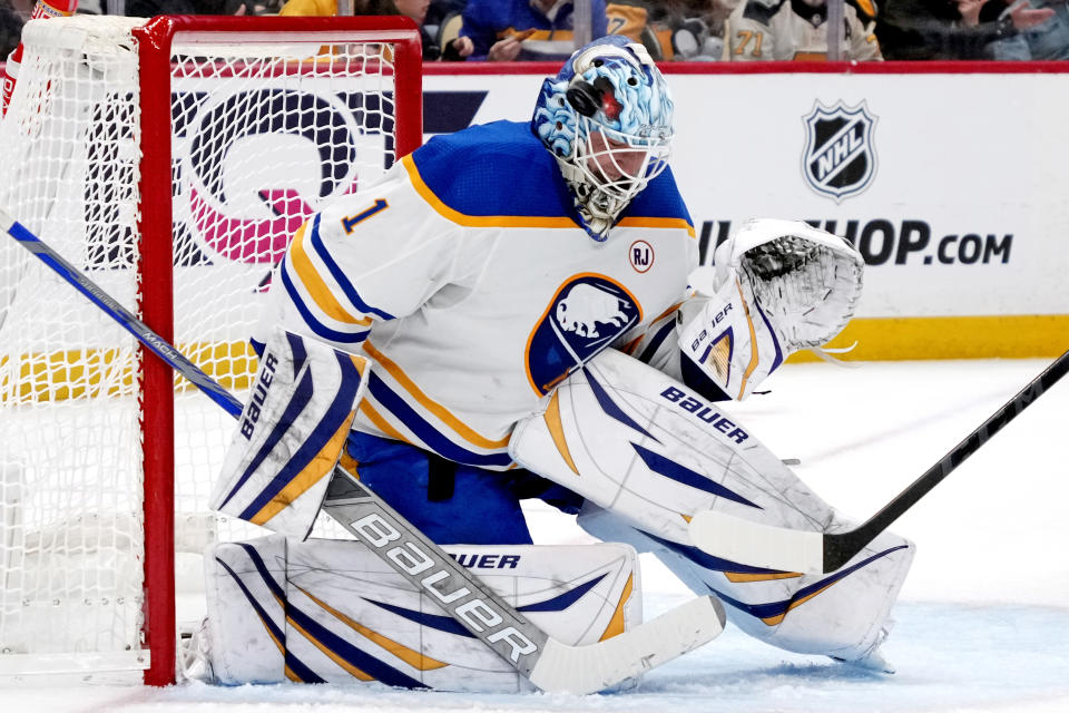 A shot bounces off the face mask of Buffalo Sabres goaltender Ukko-Pekka Luukkonen during the period of an NHL hockey game against the Pittsburgh Penguins in Pittsburgh, Saturday, Nov. 11, 2023. (AP Photo/Gene J. Puskar)