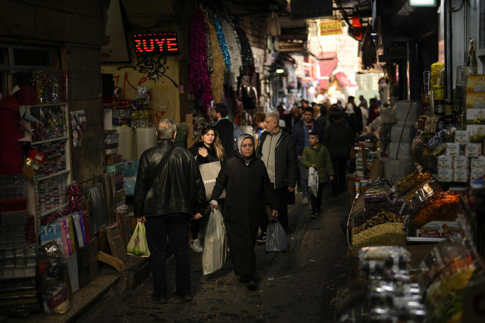 People walk along an alley at Eminonu commercial area in Istanbul, Turkey, Wednesday, Feb. 7, 2024. Turkey's new Central Bank chief says tight fiscal policies to tame inflation will continue "with determination" forecasting a 14 per cent inflation rate by the end of 2025. (AP Photo/Francisco Seco)