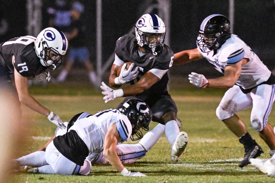 Central Valley Christian's Bryson Donelson runs through Clovis North defender in a non-league high school football game Friday, September 8, 2023.