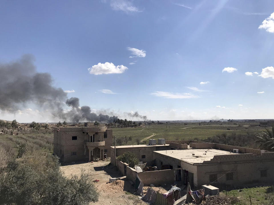 Columns of black smoke rise from the last small piece of territory held by Islamic State militants as U.S. backed fighters pound the area with artillery fire and occasional airstrikes, as seen from outside Baghouz, Syria, Sunday, March 3, 2019. Commanders of a U.S.-backed Syrian force fighting the Islamic State group in Syria say intense fighting is taking place as fighters advance toward the last piece of territory held by the extremists. (AP Photo/Sarah El-Deeb)