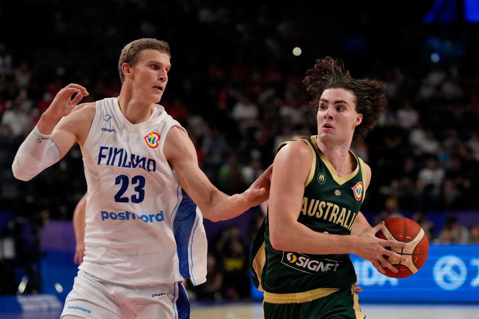 Australia guard Josh Giddey (3), right, drives against Finland forward Lauri Markkanen (23) during the second half of the Basketball World Cup group E match between Finland and Australia in Okinawa, southern Japan, Friday, Aug. 25, 2023. (AP Photo/Hiro Komae)