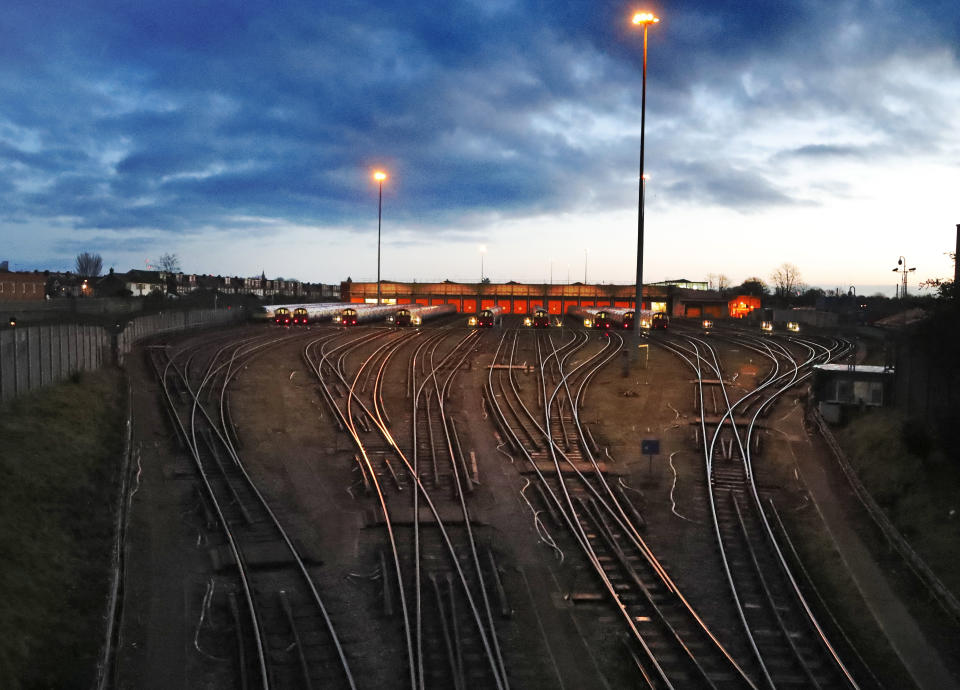 Tube trains are parked at the Boston Manor depot at sunrise in London, Sunday, Jan. 17, 2021, during England's third national lockdown since the coronavirus outbreak began. Transport for London, TfL, aims to run as close to normal services as possible to enable social distancing when travelling, although people are asked to stay home while the U.K. is under an indefinite national lockdown to curb the spread of the new coronavirus variant. (AP Photo/Frank Augstein)