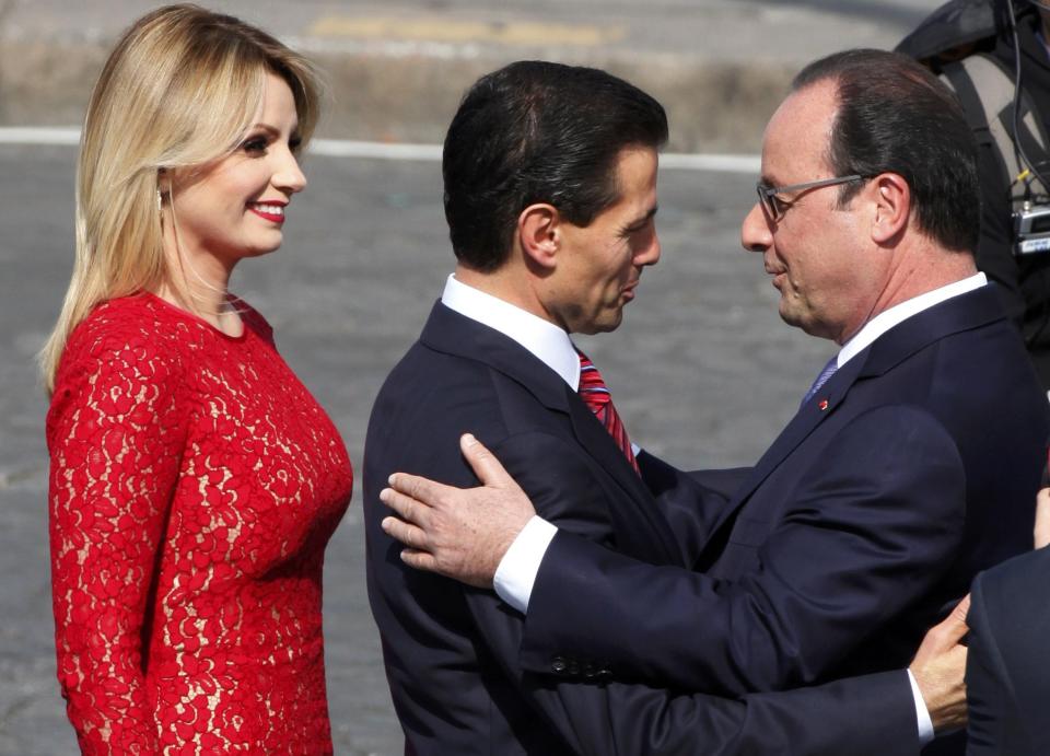 French President Francois Hollande greets Mexico's President Enrique Pena Nieto and Mexico's First Lady Angelica Rivera at the start of the traditional Bastille Day military parade in Paris