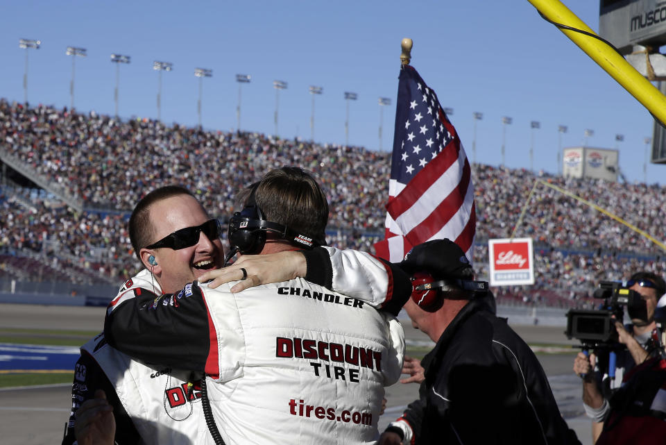Brad Keselowski's pit crew celebrates after Keselowski won the NASCAR Nationwide Series auto race Saturday, March 8, 2014, in Las Vegas. (AP Photo/Isaac Brekken)