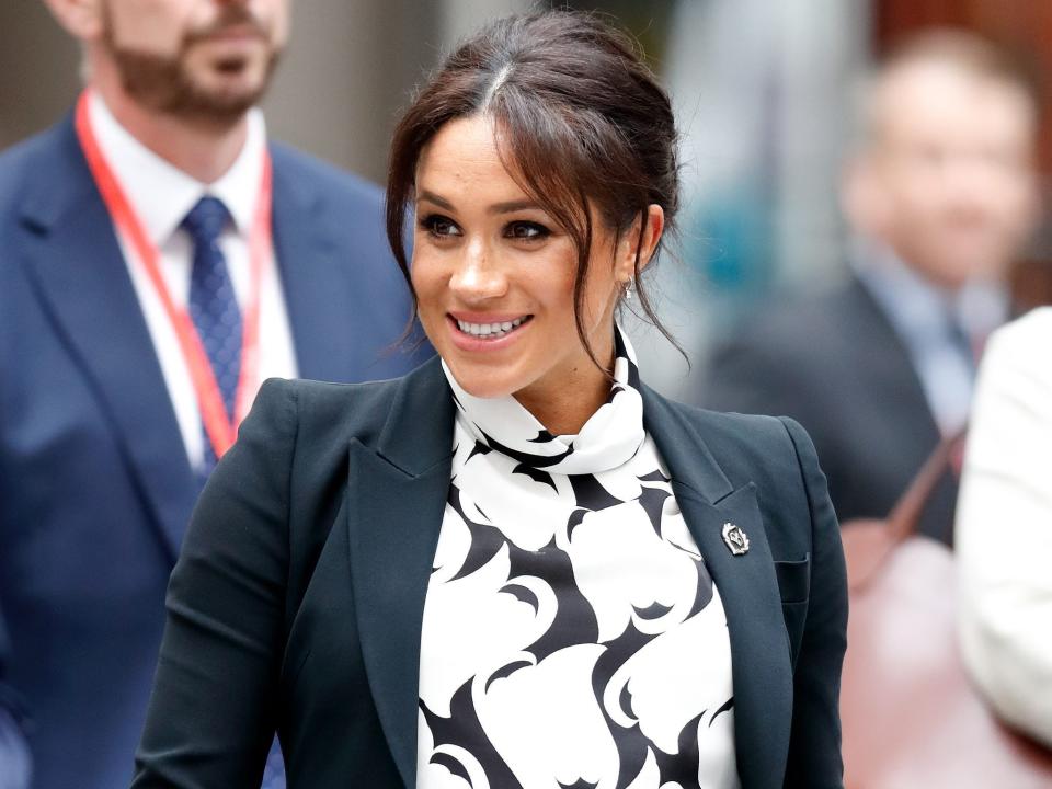 Meghan Markle wears a black and white minidress in 2019.