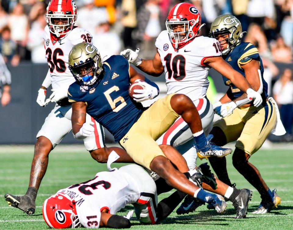 Georgia Tech running back Jamious Griffin (6) is tripped up in the backfield by Georgia defensive back William Poole (31) during the Bulldogs 45-0 win Saturday in Atlanta.