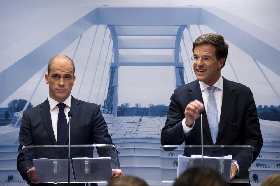 Netherlands' caretaker Prime Minister Mark Rutte, right, and Labor Party Leader Diederik Samsom, left, are seen in front of a picture symbolizing the theme of the new government, "building bridges", during a joint news conference in The Hague, Netherlands, Monday, Oct. 29, 2012. The Netherlands is close to getting a new coalition government after lawmakers from the two biggest parties approved a policy deal hammered out by their leaders. Rutte, leader of the pro-free market VVD party, and center-left Labor Party chief Samsom have been negotiating behind closed doors for weeks to resolve policies for their proposed coalition. (AP Photo/Peter Dejong)