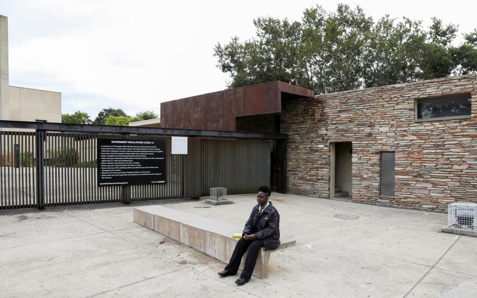 A security officer sits at the entrance of the Apartheid Museum, now closed - Reuters