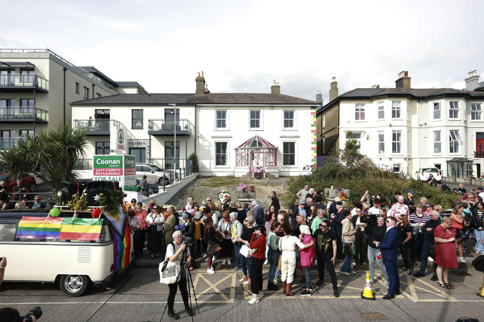 Fans gather outside the former home of Sinead O'Connor ahead of the late singer's funeral, in Bray, Co Wicklow, Ireland, Tuesday, Aug. 8, 2023. O’Connor’s family has invited the public to line the waterfront in Bray on Tuesday as her funeral procession passes by. Fans left handwritten notes outside her former home, thanking her for sharing her voice and her music. (Liam McBurneyPA via AP)