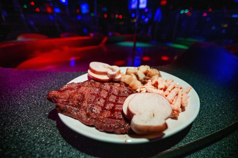 A steak meal with pasta salad, potatoes, and bread at Centerfold on Wednesday, May 31, 2023.