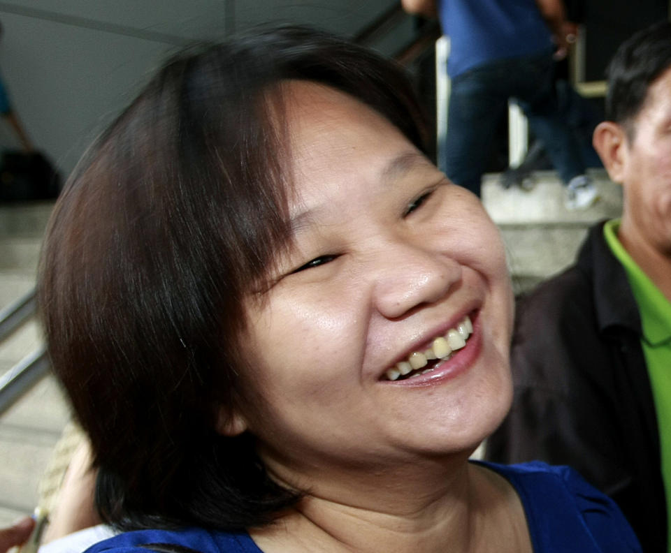 Chiranuch Premchaiporn, director of Prachatai website, smiles as she talks with reporters at the criminal court in Bangkok, Thailand Wednesday, May 30, 2012. A Thai court sentenced Chiranuch to an eight-month suspended sentence for failing to act quickly enough to remove Internet posts deemed insulting to Thailand's royalty. (AP Photo/Apichart Weerawong)