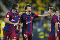 Barcelona's Joao Felix, center, celebrates after scoring the opening goal during the Spanish La Liga soccer match between Cadiz and Barcelona in Cadiz, Spain, Saturday, April 13, 2024. (AP Photo/Jose Breton)