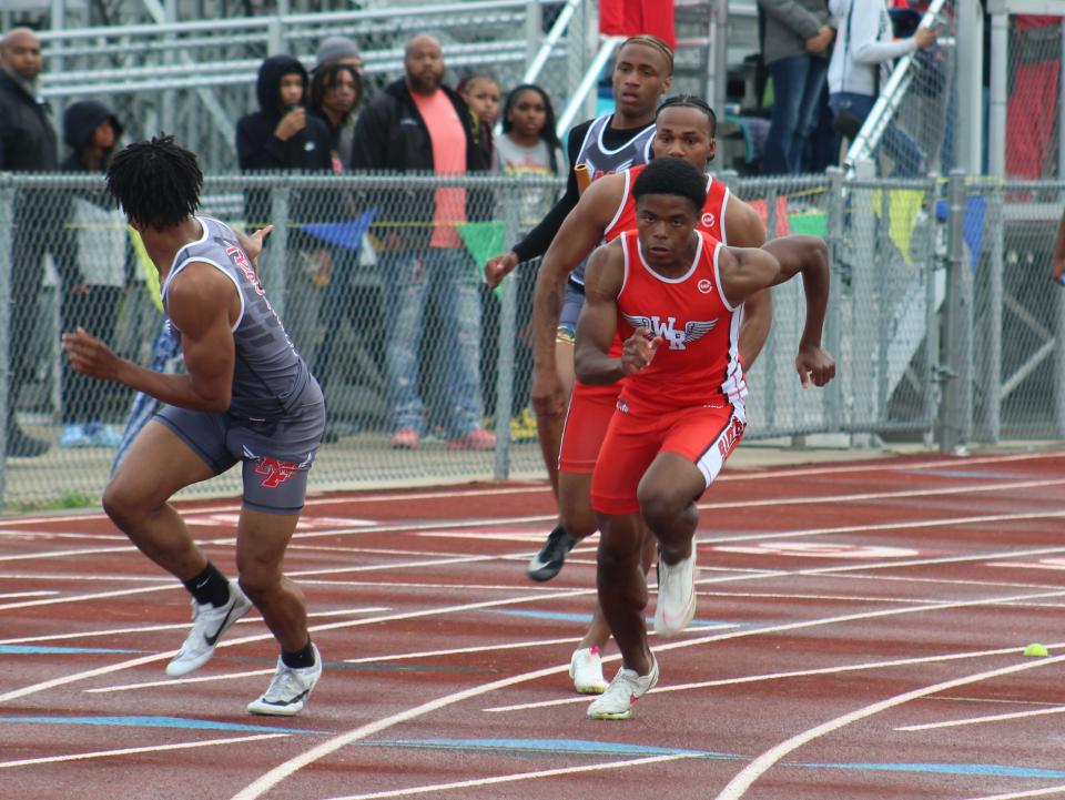 Walnut Ridge's Christian Turner takes off and prepares to receive the baton from Rakim Smith during the 800-meter relay in the City League track and field meet Thursday at Africentric. The Scots won the race (1:29.21) on their way to winning the league title.