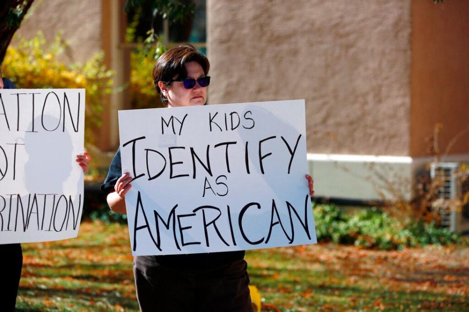 People protest outside the offices of the New Mexico Public Education Department's office, Nov. 12, 2021, in Albuquerque. The education department proposed changes to the social studies curriculum that critics describe as a veiled attempt to teach critical race theory. Supporters say the new curriculum, which includes ethnic studies, is "anti-racist."