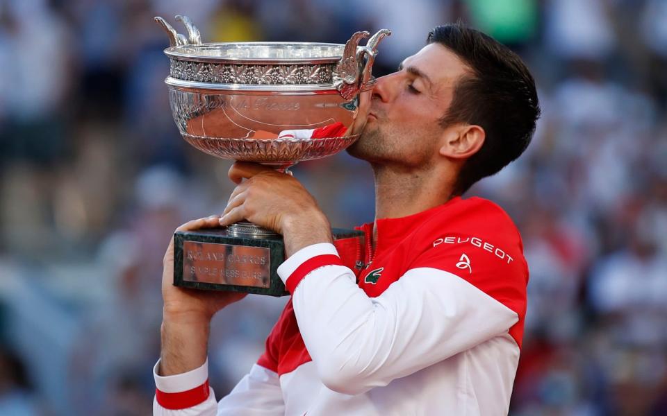 Novak Djokovic lifts his second French Open trophy, for his 19th major overall - Reuters