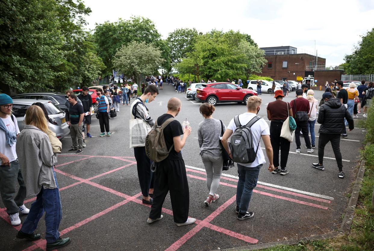 People queue outside a vaccination centre in Harrow (REUTERS)