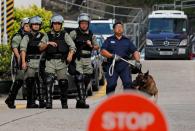 Members of the Correctional Emergency Response Team stand guard as they wait for Chan Tong-kai, a Hong Kong citizen who was accused of murdering his girlfriend in Taiwan last year, to leave from Pik Uk Prison, in Hong Kong