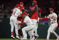 Cincinnati Reds' Spencer Steer (12) celebrates with teammates after hitting the game-winning RBI double in the ninth inning of a baseball game against the Chicago Cubs Tuesday, Oct. 4, 2022, in Cincinnati. (AP Photo/Jeff Dean)