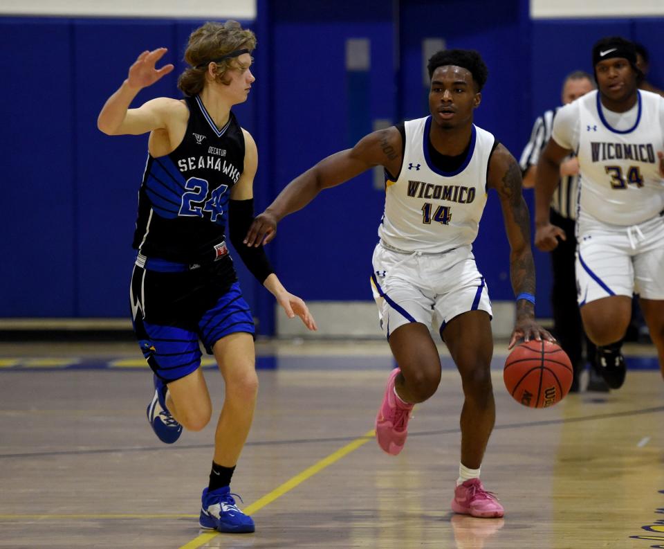 Wi-Hi's Antwan Wilson (14) dribbles by Decatur's Noah Tucker (24) Monday, Jan. 9, 2023, in Salisbury, Maryland. Wi-Hi defeated Decatur 64-59.