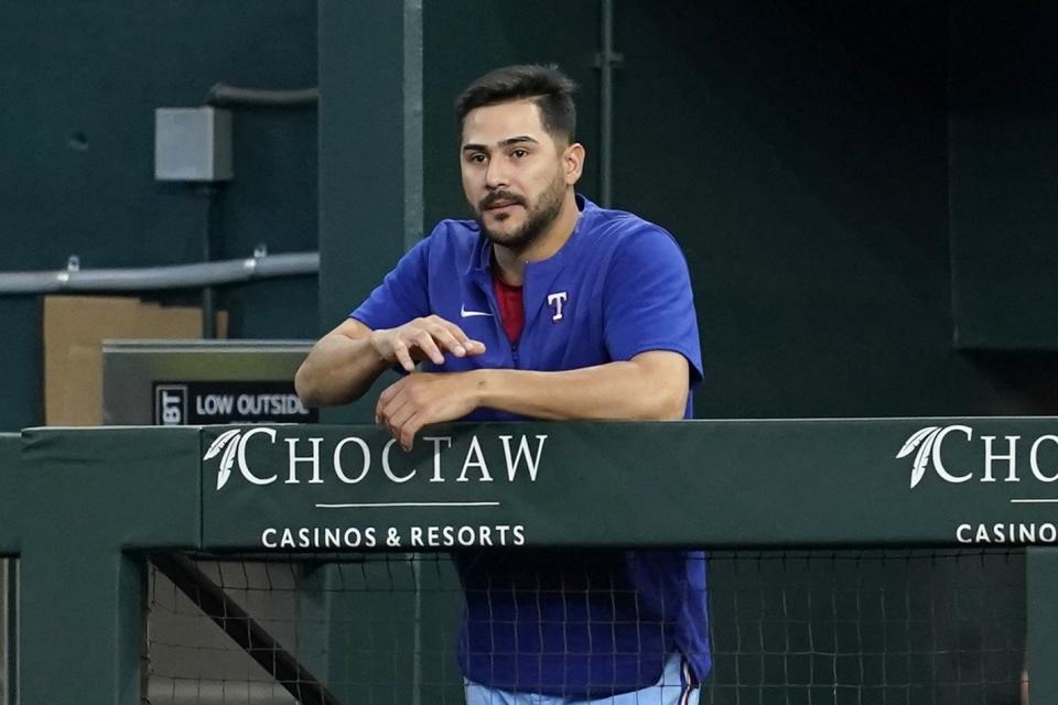 Texas Rangers' pitcher Martin Perez stands at the top of the dugout steps after it was announced in the stadium that Perez was selected to the All Star game during a baseball game against the Minnesota Twins, Sunday, July 10, 2022, in Arlington, Texas. (AP Photo/Tony Gutierrez)