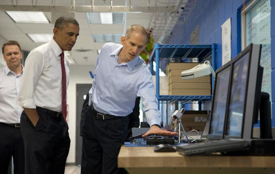 President Barack Obama tours Vacon, a research and development center and lab for high-power AC drives, with Vacon Vice President Dan Isaksson, left, and Vacon engineer Rod Washington, right, Wednesday, Jan. 15, 2014, in Durham, N.C., before traveling to North Carolina State University where he will speak about the economy, jobs and manufacturing. (AP Photo/Carolyn Kaster)