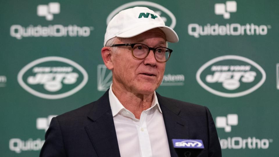 Jets owner Woody Johnson sits at the podium during the Aaron Rodgers introductory news conference.