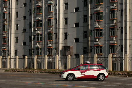 FILE PHOTO: A BYD E6 electric car, used as a taxi in Shenzhen, is seen in a car park in the southern Chinese city of Shenzhen May 24, 2010. REUTERS/Tyrone Siu/File Photo