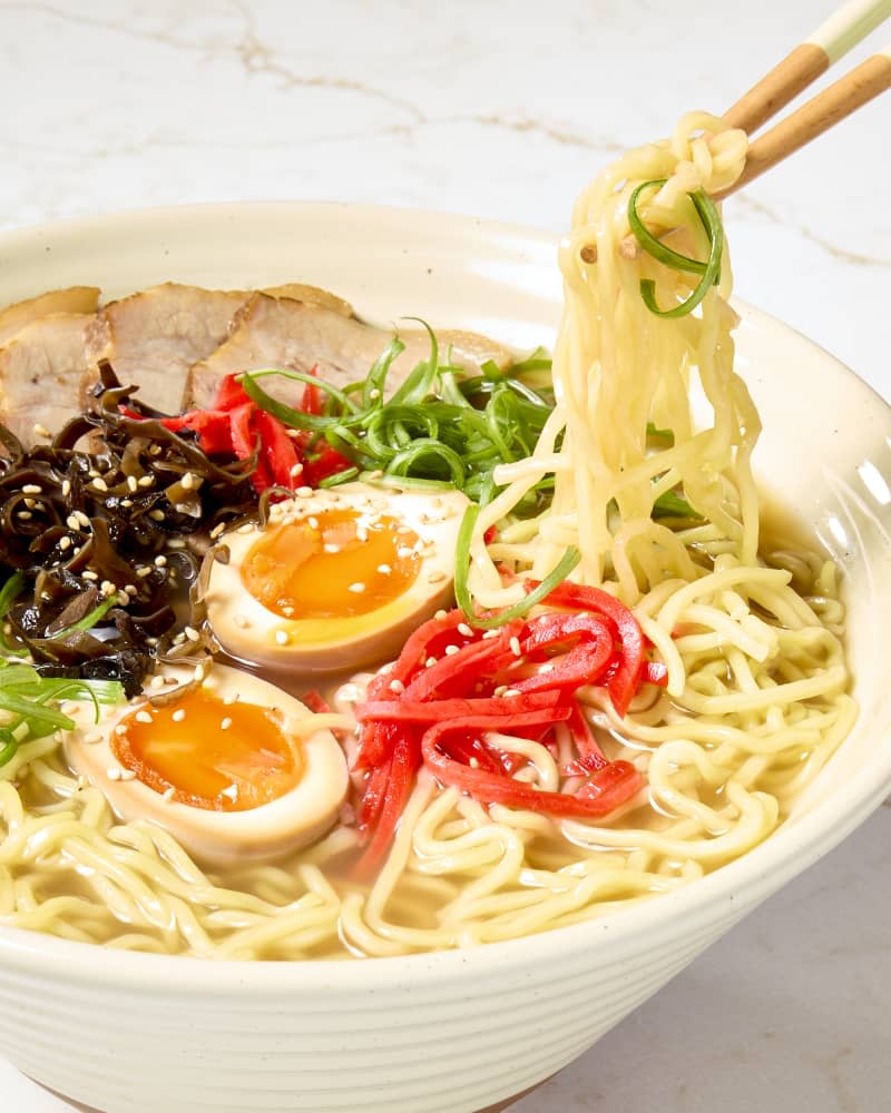 side shot of a bowl of tonkotsu ramen, with various toppings.